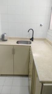 a kitchen with a sink and a counter top at شقه غرفتين وصاله الاربعين in Riyadh