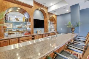 a kitchen with a large counter with stools at Sky Suite at 300 Drayton in Savannah
