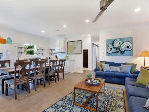 a living room and dining room with a blue couch at Lime Time in Tybee Island