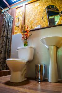 a bathroom with a toilet and a sink at Amazon Planet in Tambopata