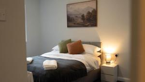 a bedroom with a bed with a painting on the wall at Langcliffe House - 3 Bed, Sleeps 5 - Garden, Parking & Wifi - Warwick in Warwick