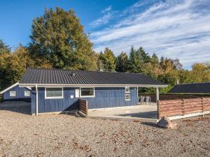 a blue building with a fence in front of it at Seaside Haven with Spa - By Traum Ferienwohnungen in Sønder Bjert
