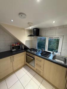 a kitchen with a sink and a stove top oven at Central London double bed apartment Free Parking Incl Stays upto 6 in London