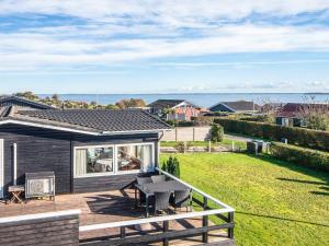 a house with a deck with a view of the ocean at Panoramic Cottage Retreat-By Traum in Hejls