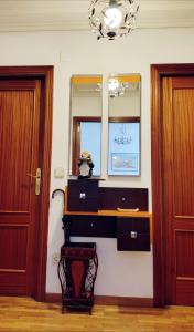a room with a sink and a mirror and two doors at Confortable y luminoso apartamento in Valladolid