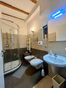 a bathroom with two toilets and a shower and a sink at Charming Ringhiera Studio in Milan