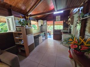 a large kitchen with wooden ceilings and a large floor at Chalet Plage et Kite in Le Vauclin +16 photos