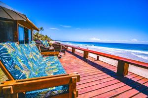 a wooden deck with benches on the beach at Mar a Vista Charme by Concavus in Porto De Galinhas +13 photos