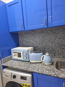 a kitchen counter with a microwave and a toaster at Delta Sharm pool view Studio Shahrazad in Sharm El Sheikh