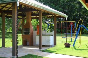 a pavilion with a playground in a park at Hotel Kaeru in Avaré