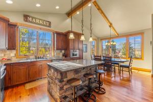 a kitchen with wooden cabinets and a stone counter top at Ravenswood- Lake views- downtown greystone with air conditioning in McCall