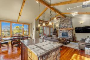 a kitchen and living room with a fireplace at Ravenswood- Lake views- downtown greystone with air conditioning in McCall