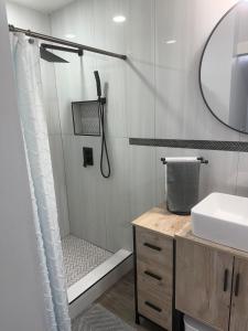 a bathroom with a shower with a sink and a mirror at Tree of life in Temple +26 photos