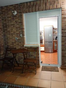 a kitchen with a table and a refrigerator at APARTAMENTO COSTA CANTABRIA in Cuchia