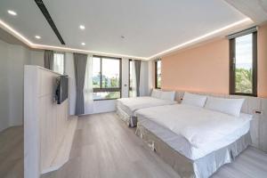 Postel nebo postele na pokoji v ubytování 融舍Villa 花蓮景觀包棟民宿 + 2 fotografie