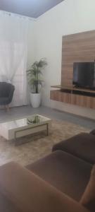 a living room with a couch and a coffee table at Casa em Belém cop 30 in Belém