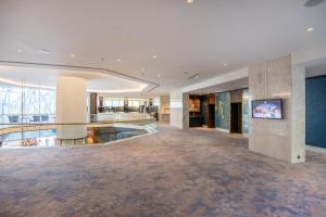 an empty lobby of a building with a flat screen tv at InterContinental Lisbon by IHG in Lisbon
