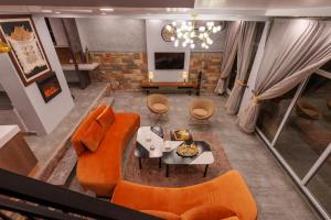 an overhead view of a living room with orange furniture at Murree Hills Executive 3 Bedroom Cottage with Scenic View in Murree
