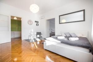 - une chambre avec un lit blanc et du parquet dans l'établissement Apartment Ribnjak, à Zagreb