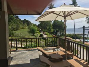 a patio with two chairs and an umbrella at 2100 veranda condo Kembali in Davao City