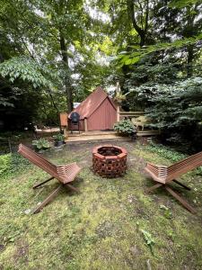 two chairs and a fire pit in a yard with a tent at Romantic Botanical Bell Tent for a Fantastic Glamping Experience in Southbury, Connecticut in Southbury