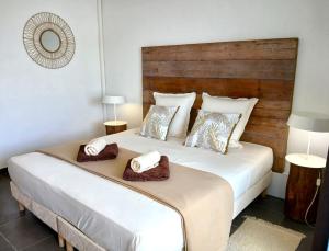 a bedroom with a large white bed with two pillows at Studio Le Sablé in Îlet à Christophe +7 photos