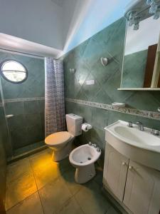 a bathroom with a toilet and a sink at Hotel Spileon in Villa Gesell