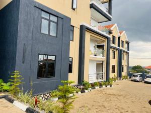 a house with a lot of plants in front of it at Breathtaking Nest 2, cosy and spacious in Kampala
