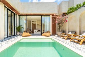 a pool in the backyard of a house at Casa Admire Villas in Legian