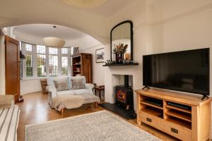 a living room with a flat screen tv and a fireplace at Summerfield in Conwy