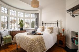 a bedroom with a bed with a tray of food on it at Summerfield in Conwy