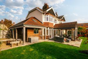 a house with a patio and a lawn at Summerfield in Conwy