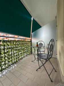 a table and a chair on a patio at La Maison De Milan San Siro in Milan