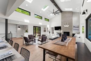 a dining room and living room with a table and chairs at Fox Run w/Heated Pool & Optional Boat Rental in Westport