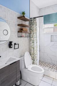 a bathroom with a toilet and a sink and a shower at Garden Apartment in Trinity +12 photos