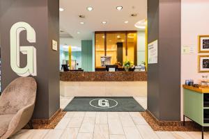 a lobby with the cg logo on the floor at Garner Hotel Dusseldorf - Main Station by IHG in Düsseldorf