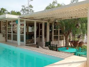 a house with a swimming pool and a pergola at Bed0Bled Cabanes & Holiday homes in Sidi Kaouki