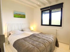 a bedroom with a bed and a window at Agathe in Laforêt