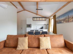 a living room with a couch and a kitchen at Westhinder I H19 in Koksijde +12 photos