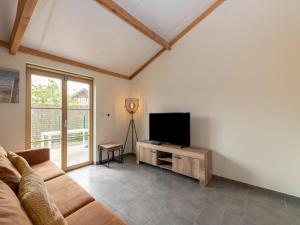 a living room with a couch and a flat screen tv at Westhinder I H19 in Koksijde