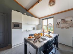 a kitchen with a table with a bowl of fruit on it at Westhinder I H21 in Koksijde +10 photos