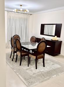 a dining room with a table and chairs at 2 Bedroom Modern Flat at Zayed in 6th Of October