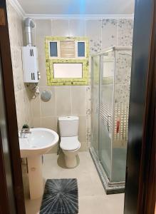 a bathroom with a toilet sink and a shower at 2 Bedroom Modern Flat at Zayed in 6th Of October +38 photos