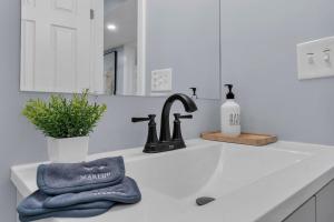 a kitchen counter with a sink and a towel at The Boho Lux Haven Prov in Providence