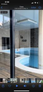 a tv screen with a picture of a swimming pool at Edificio La Rue- frente al mar in Piriápolis +11 photos