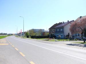 an empty street in a residential neighborhood with houses at Apartments Ro Ma A1 in Novo Selo Požeško