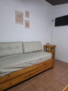 a bed in a room with a flat screen tv at Quinta Los Sauces in San Miguel del Monte