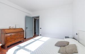a bedroom with a bed and a wooden dresser at Villa Montefiorito in Recco
