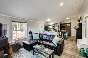 a living room with a couch and a table at Sip and Hike! Autumn Escape 12 Mi to Traverse City in Grawn