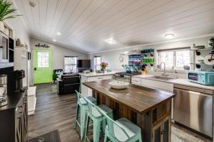 a kitchen with a wooden table and chairs at Sip and Hike! Autumn Escape 12 Mi to Traverse City in Grawn